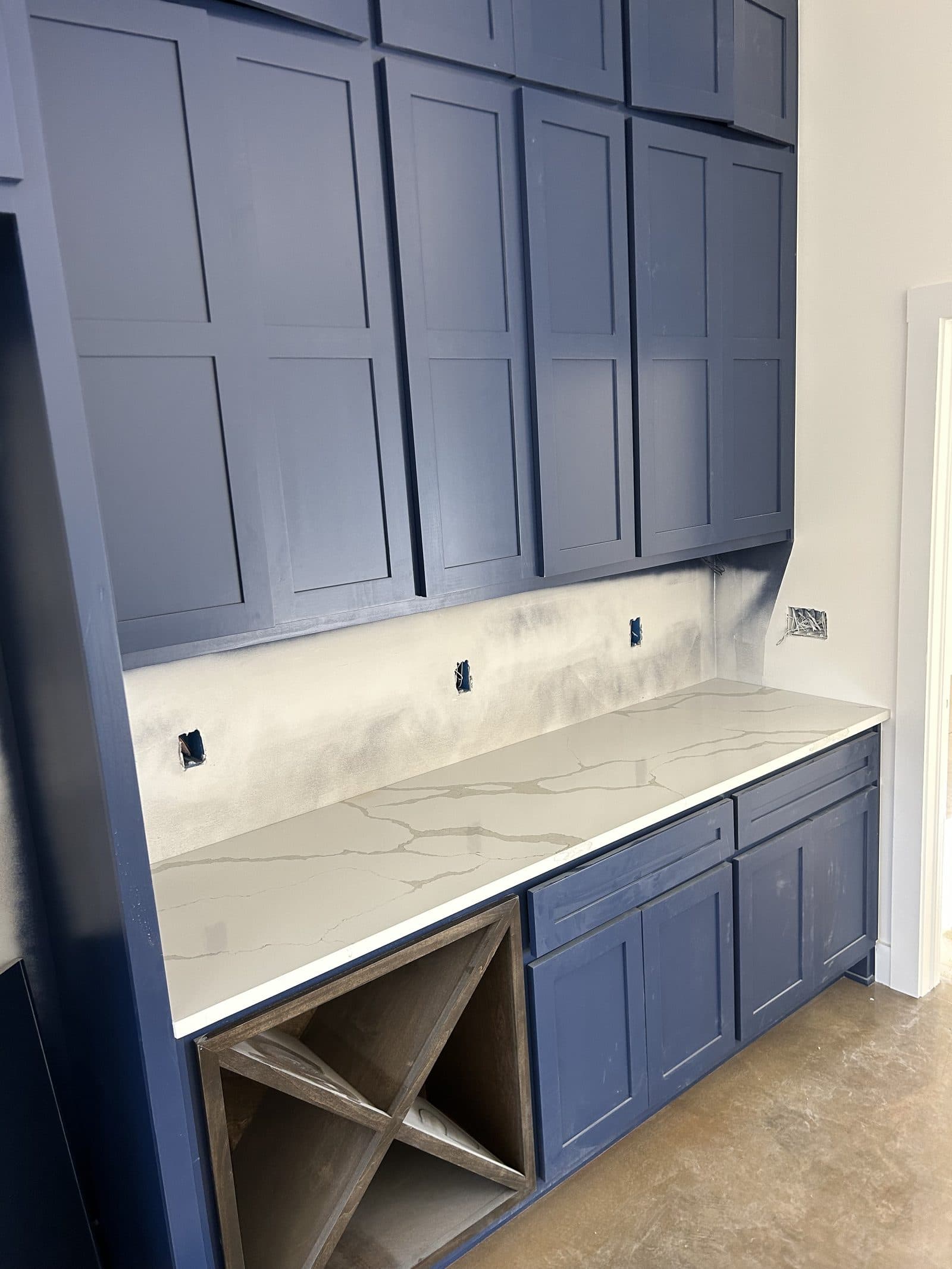 Quartz countertop with blue cabinets